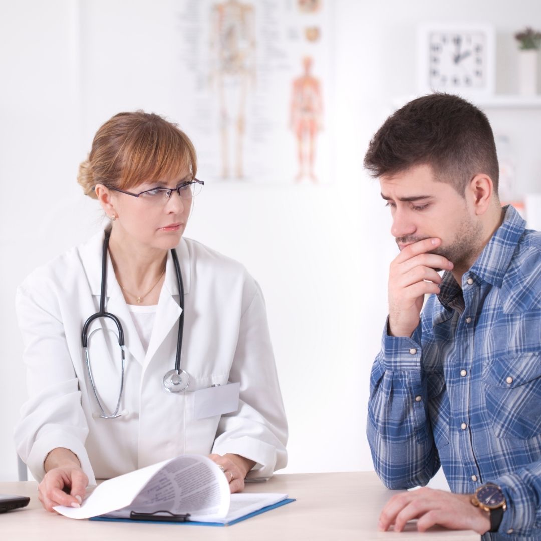 doctor showing info papers to patient